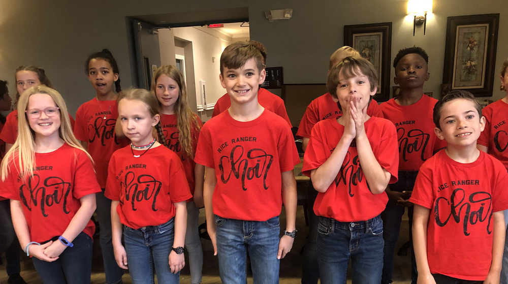 elementary age boys and girls wearing red Rice Choir tshirts