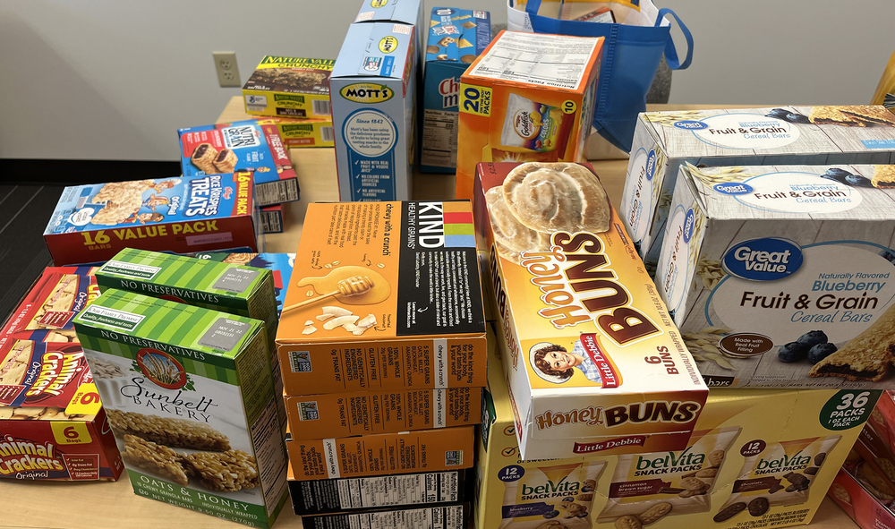 variety of snack boxes on a table - granola bars, gummies, honey buns, cereal bars