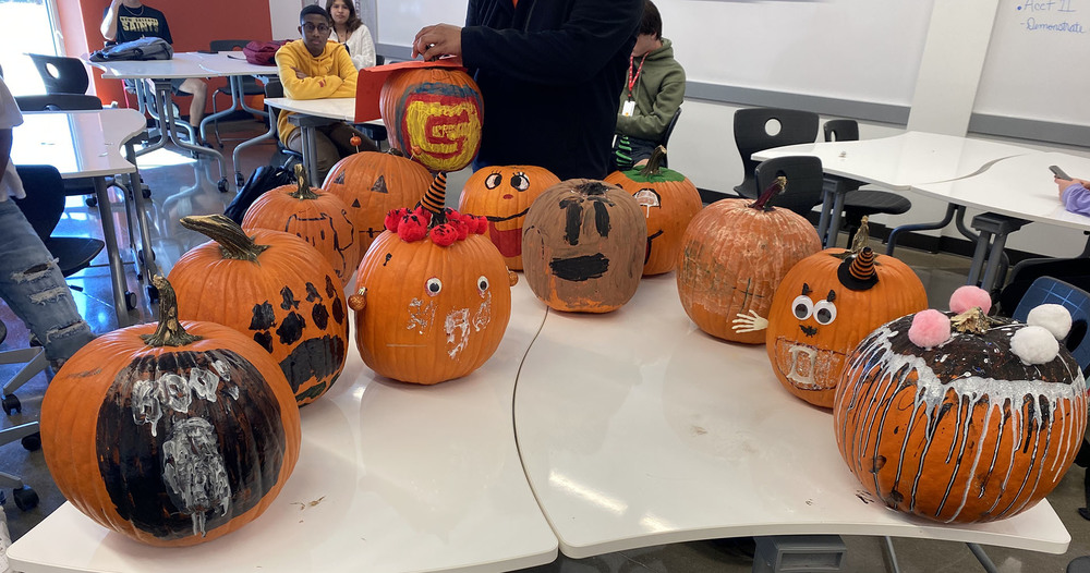 decorated pumpkins sitting on a table