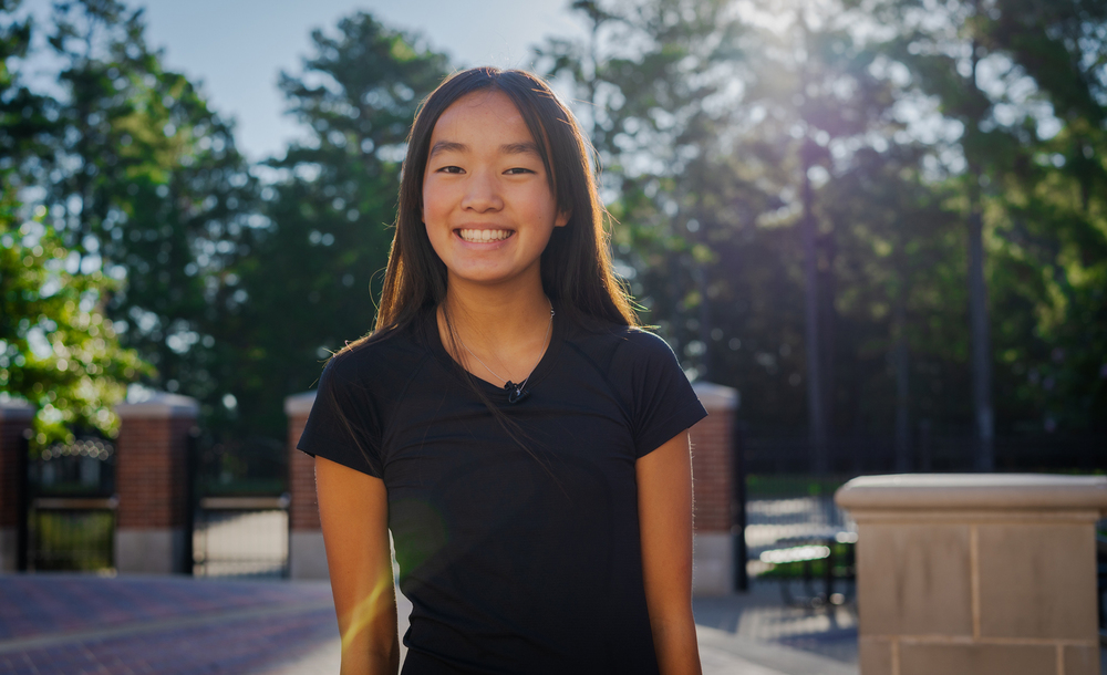 middle school age girl with long dark hair wearing a black t-shirt