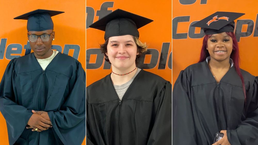 3 students in cap and gown