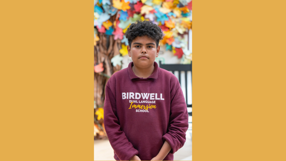 middle school age male wearing maroon Birdwell Dual Language Immersion School sweatshirt