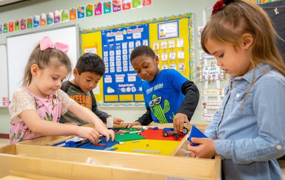 children playing at Lego table