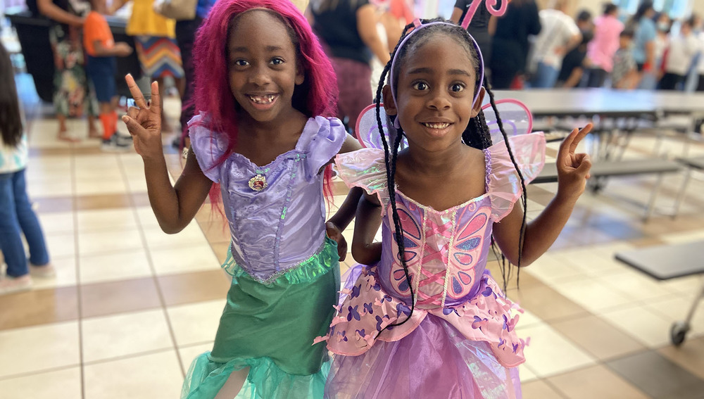 two young African American girls dressed in princess costumes