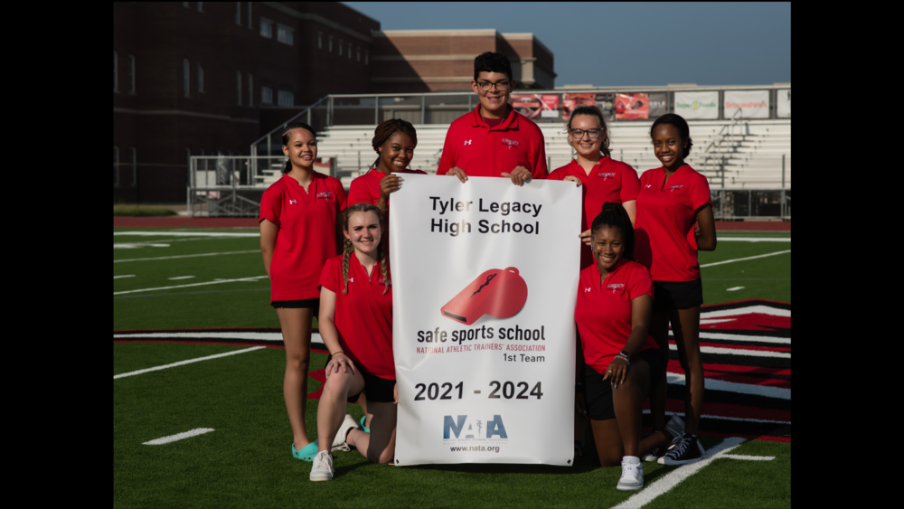 Tyler Legacy High School students holding banner that reads: safe sports school national athletic trainers' association 1st team. 2021-2024 NATA 