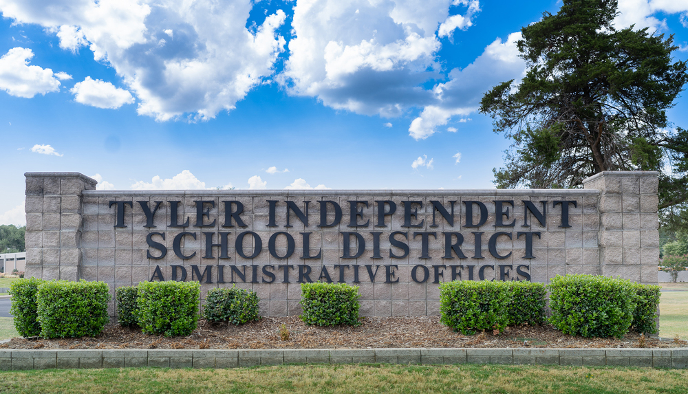 Tyler Independent School District Administrative Offices sign. blue skies and white clouds in background