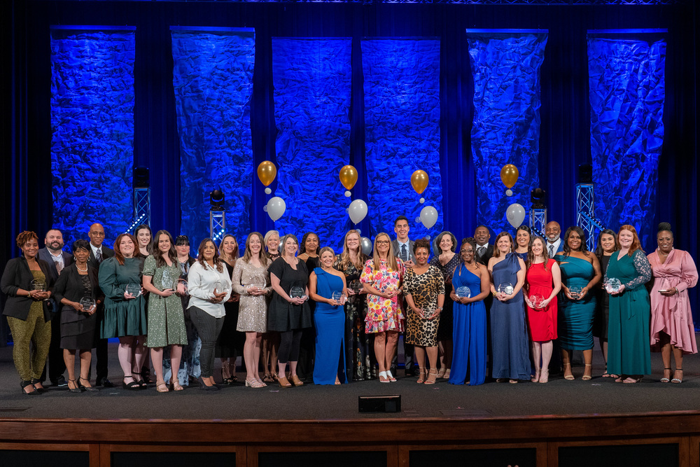 teacher nominees standing on a stage with awards