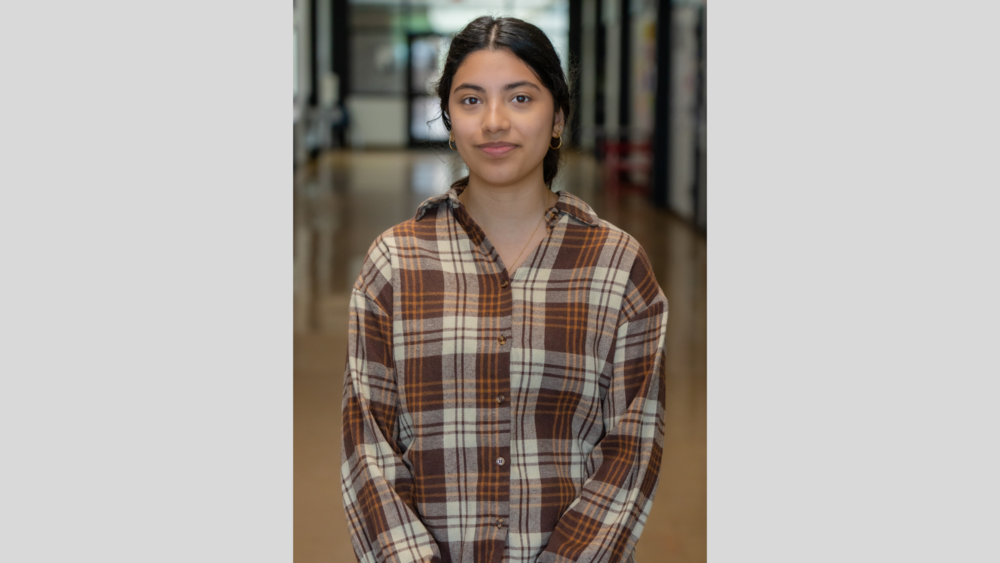 Hispanic girl wearing brown plaid shirt