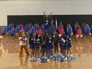cheerleaders and lion mascot in a huddle