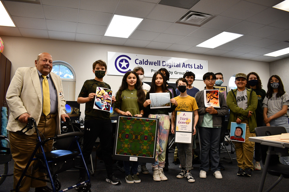 Caldwell Digital Arts Lab - students standing holding their artwork
