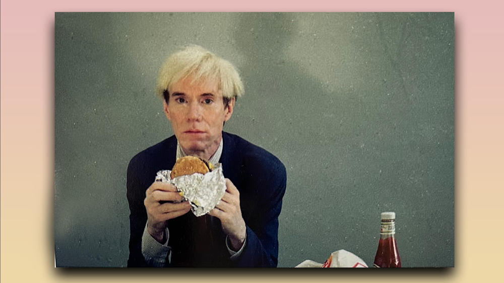 Andy Warhol eating a hamburger