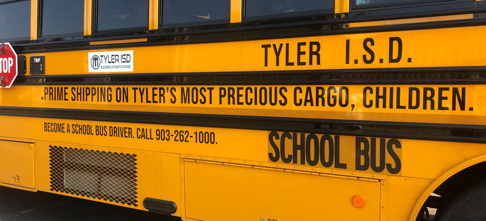 side view of Tyler ISD bus. Prime shipping on Tyler's most precious cargo, children.