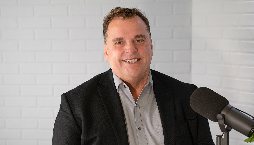 Dr. Marty Crawford in front of a microphone