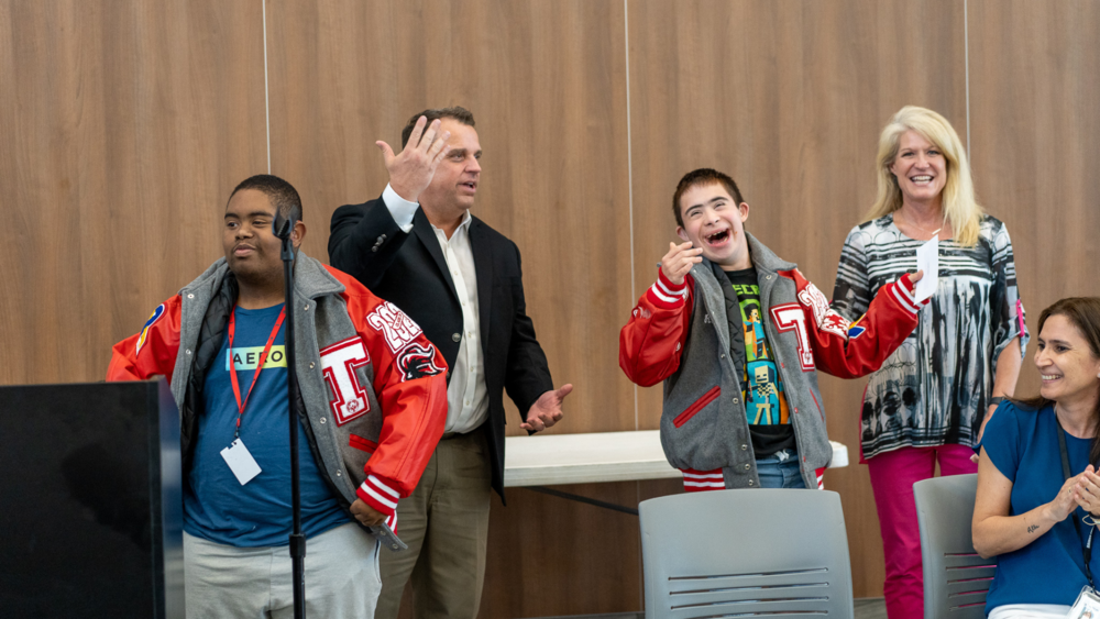 two male special education students receive their letter jackets