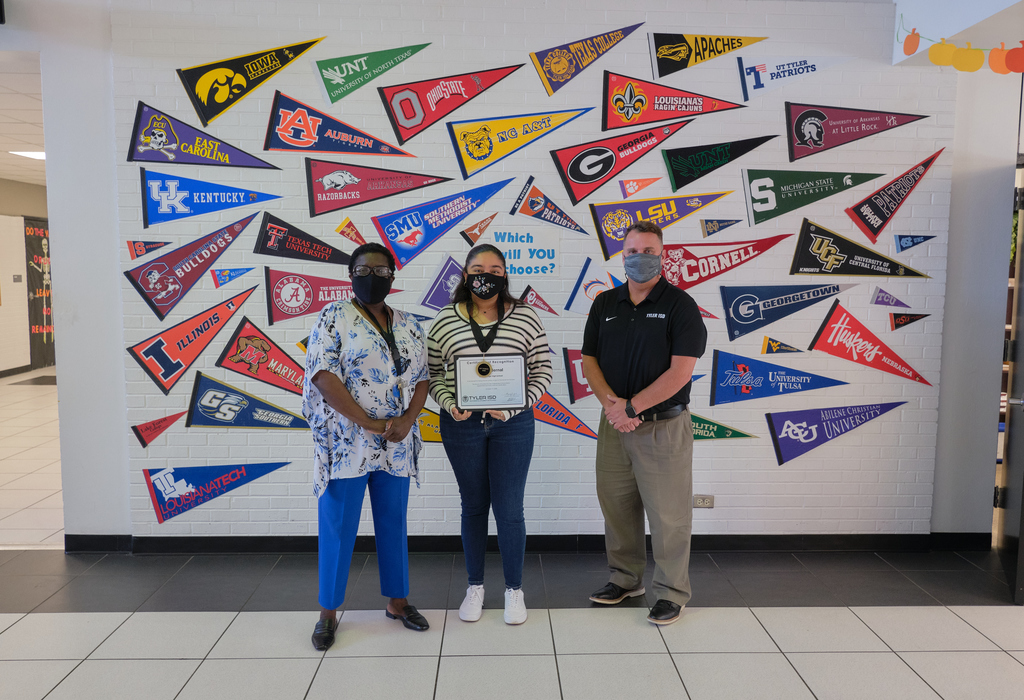 Saide Bernal, a 12th-grade student at Early College High School is the Secondary Student of the Month posing with the principal and superintendent.