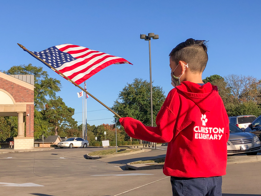 Clarkston Elementary student waving a US flag.