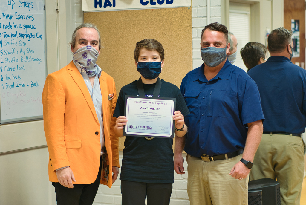 Austin Aguilar accepting his student of the month award.