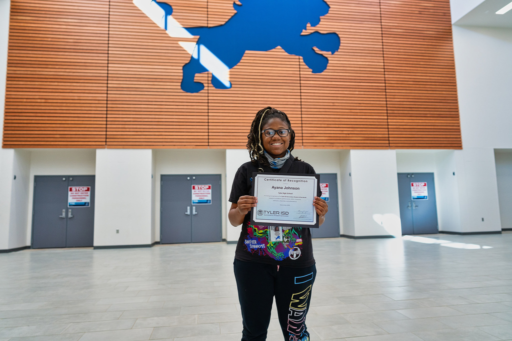 Ayana posing with her certificate.
