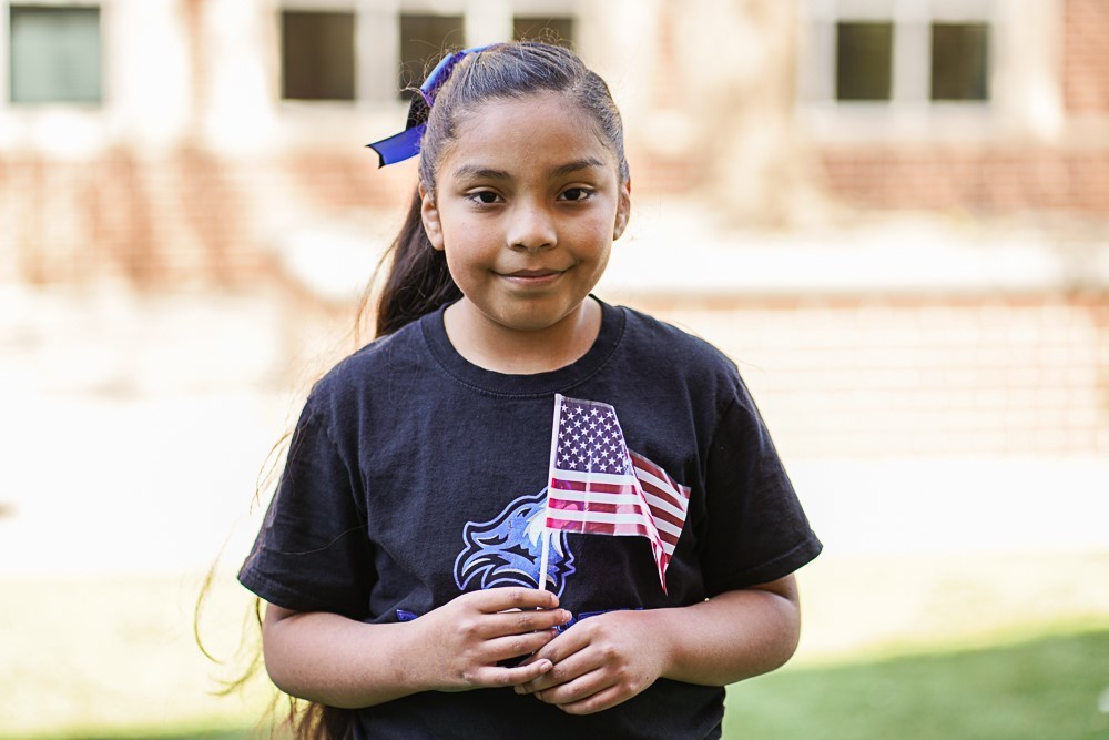 students holding a US flag