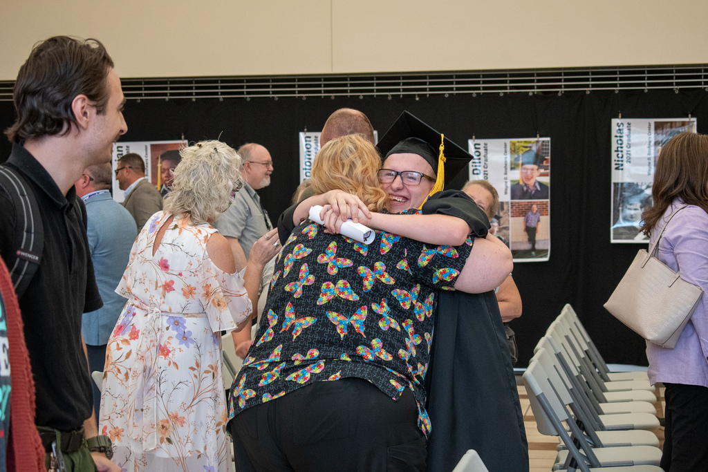 graduate hugging family