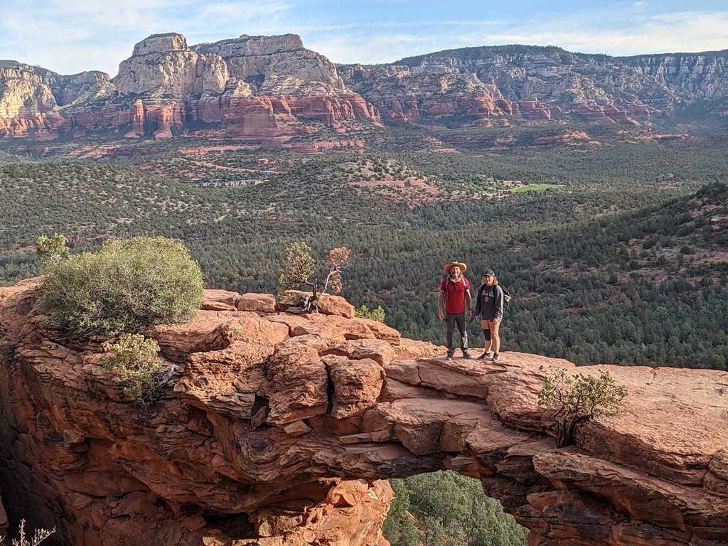Man and girl pose on top of a rock in the Grand Canyon