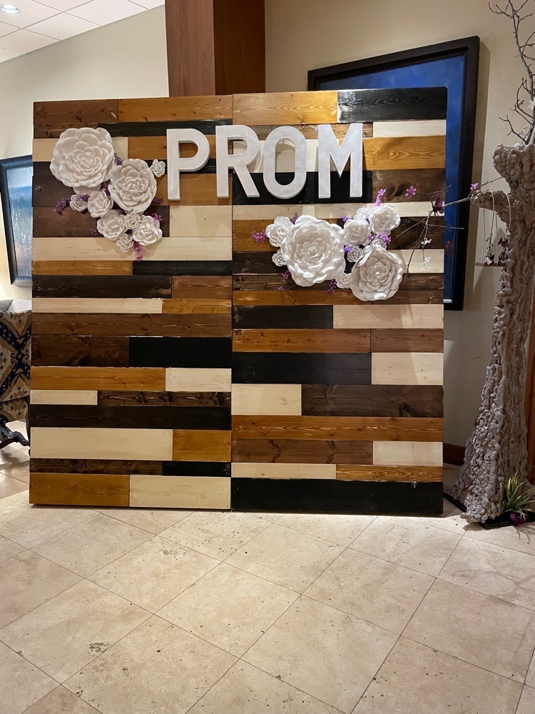 wooden wall with the words prom and flowers