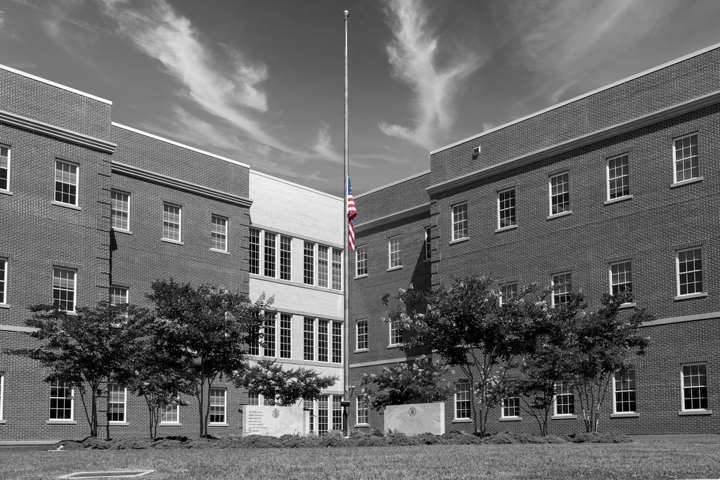 Tyler Legacy High School in black and white with US flag in color