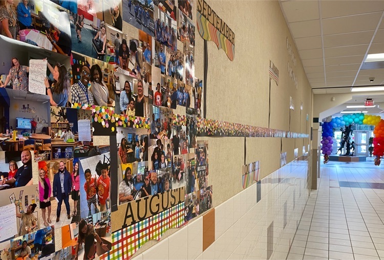 image of a wall with a monthly timeline and pictures of students and staff under august