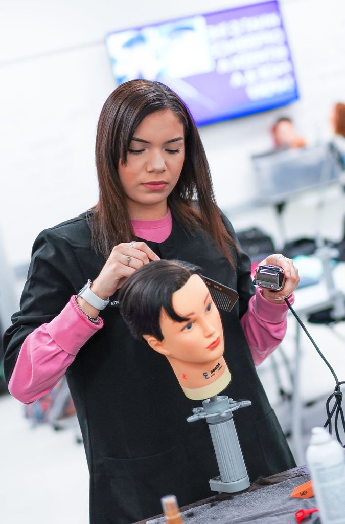 student practicing cutting hair