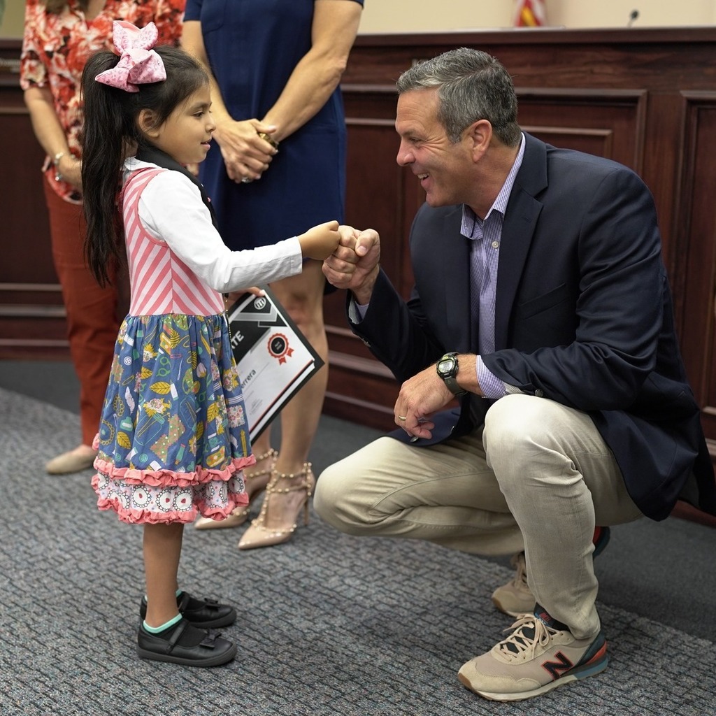 Andy fist bumping a student of the month