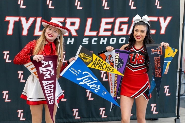 legacy cheer holding pennants