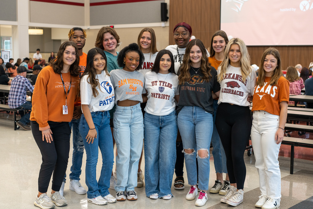 Students wearing different college shirts.
