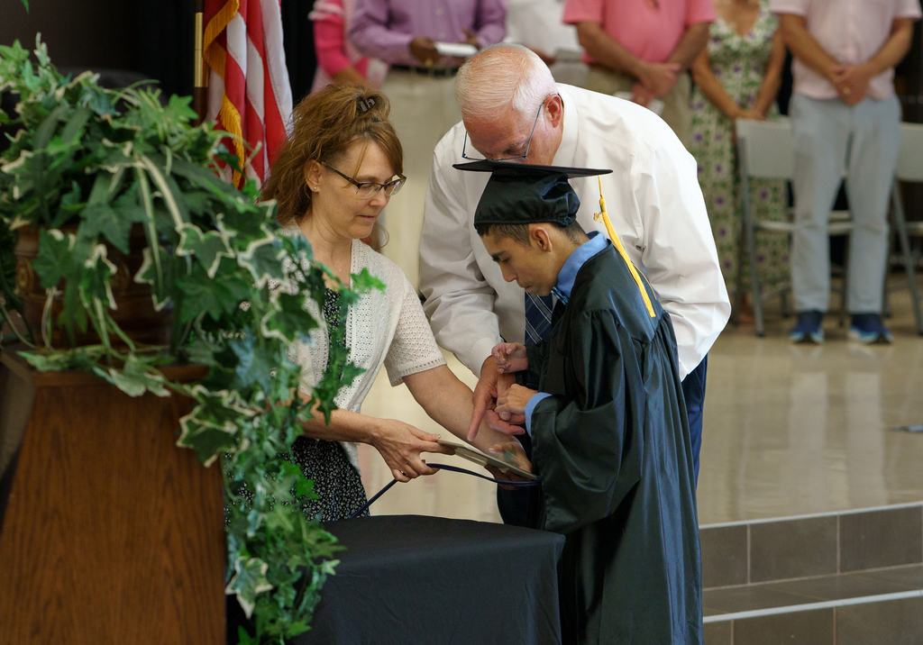 Boshears student accepting diploma.