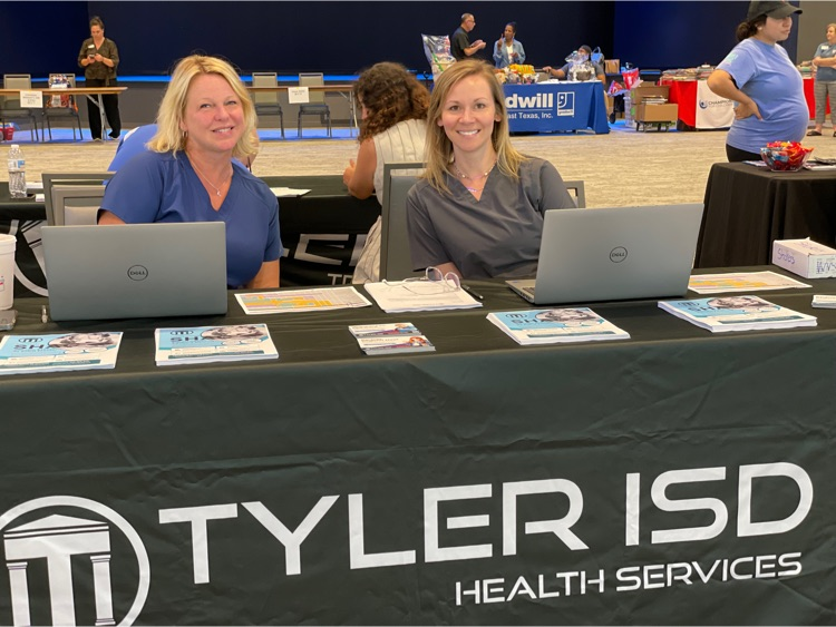 staff sitting behind Tyler ISD booth table 