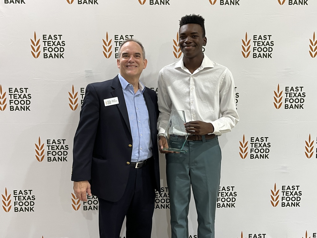 Tyler High School student standing with ETFB rep with award.