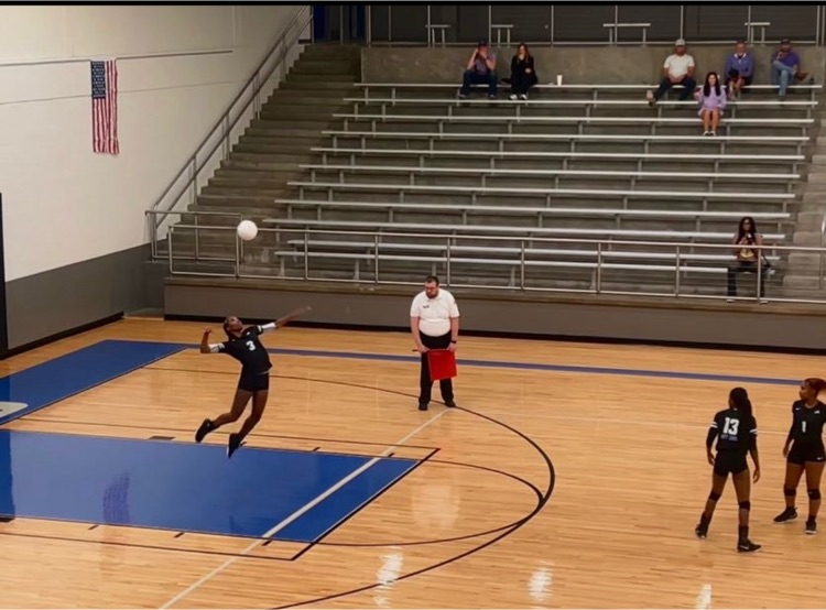 Girl serving the ball.