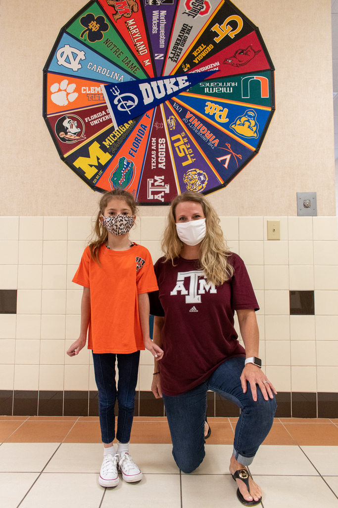 teacher and student wearing college shirts for national college colors day
